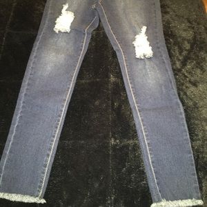 Brand new, never worn blue denim distressed jeans